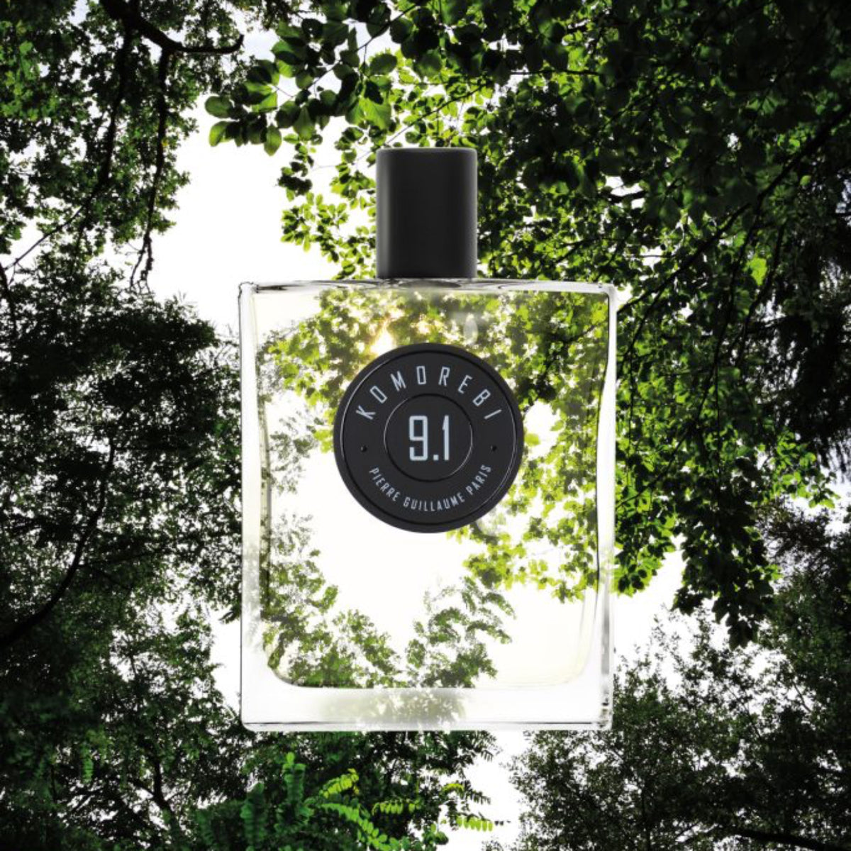 Perfume bottle labeled '9.1' with a natural background of trees